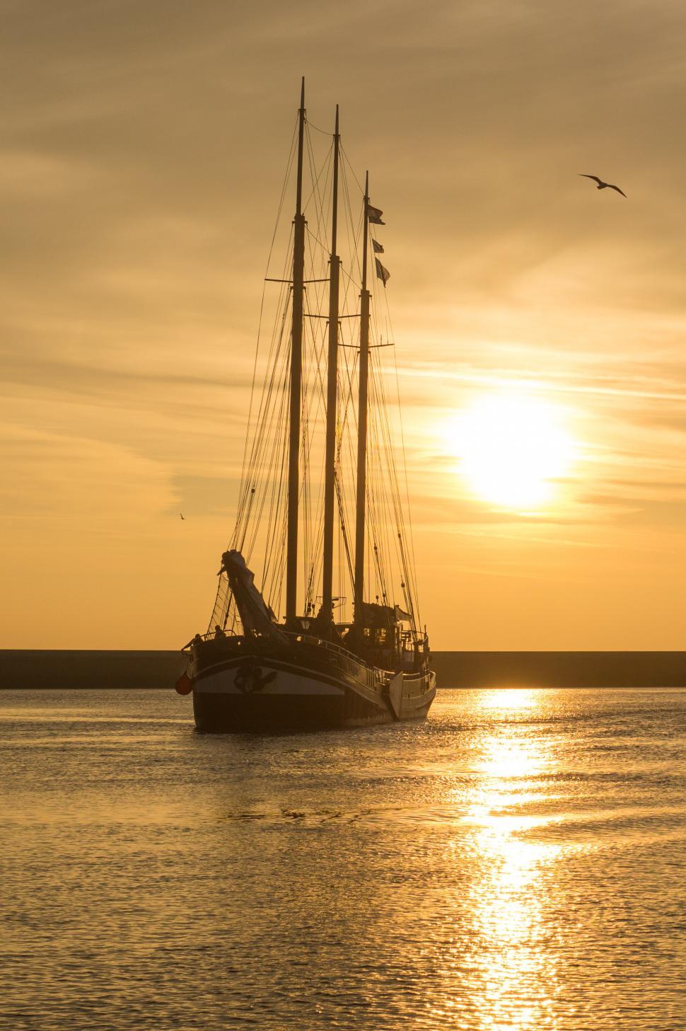 Free Image of Sailboat Sailing on Water at Sunset 