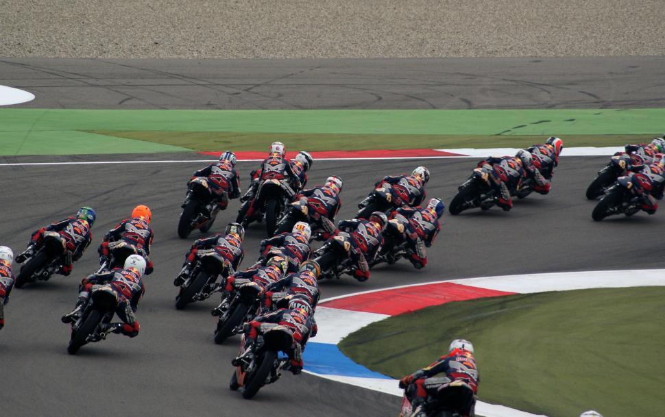 Free Image of Group of Motorcyclists Racing Around a Track 