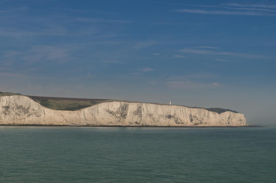 Free Image of Massive White Cliff Rising From the Water 
