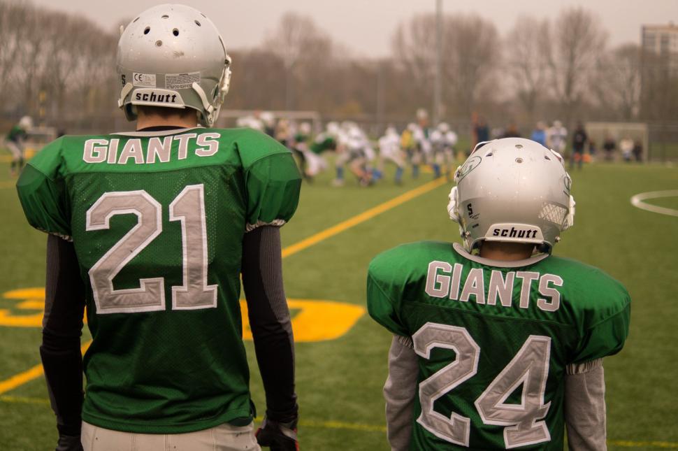 Free Image of Two Football Players Standing on the Field 