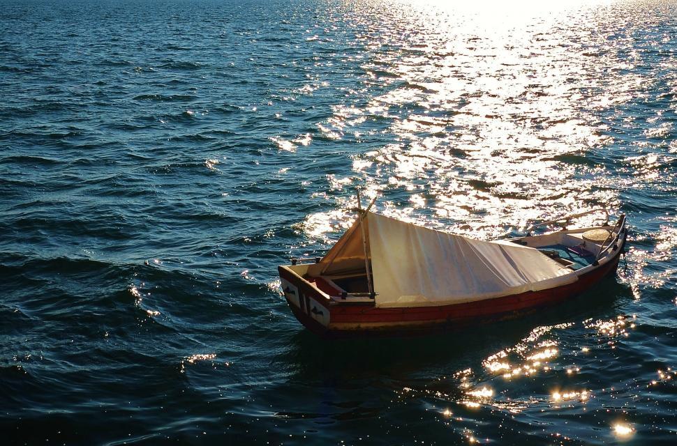 Free Image of Small Boat Floating on Large Body of Water 