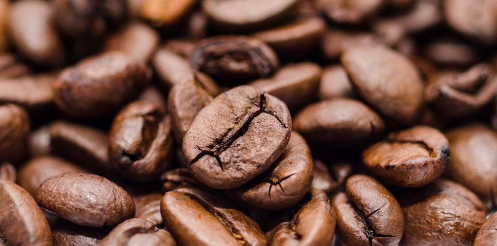 Free Image of A Pile of Coffee Beans on Brown Background 