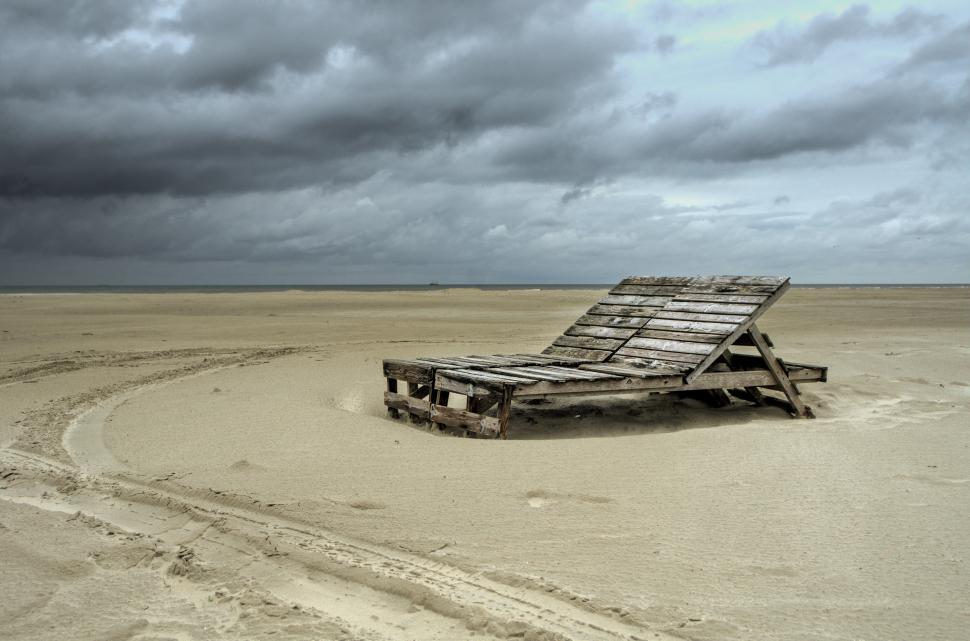 Free Image of Wooden Chair on Sandy Beach 