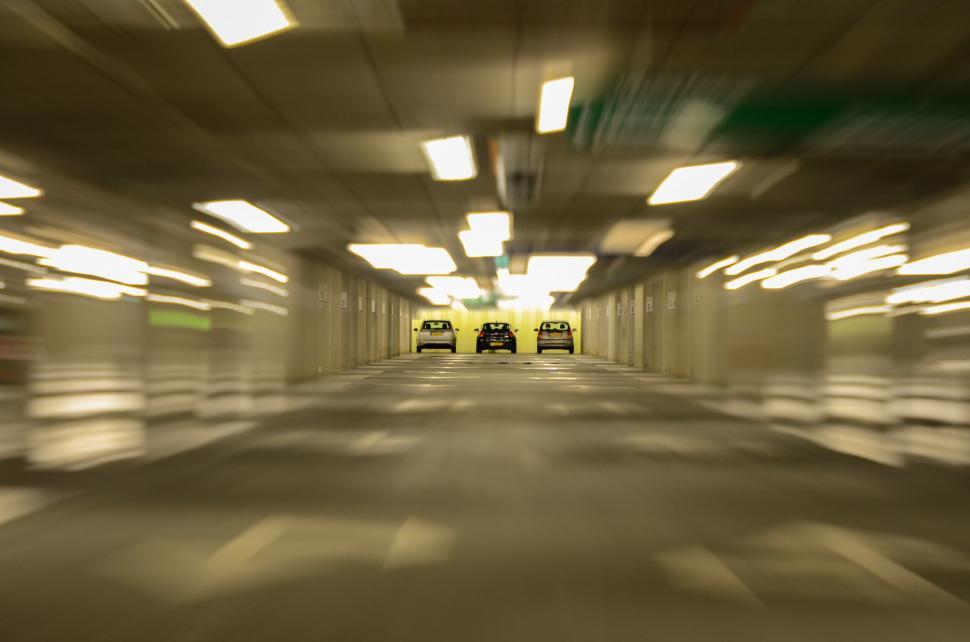 Free Image of Two Cars Parked in Empty Parking Garage 