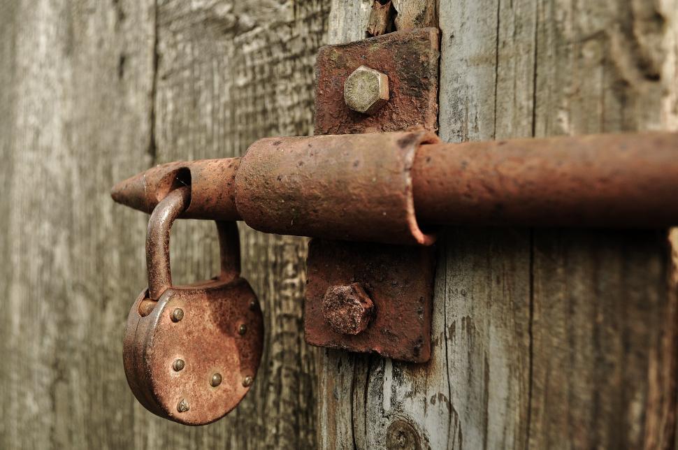 Free Image of Rusted Metal Lock on Wooden Door 