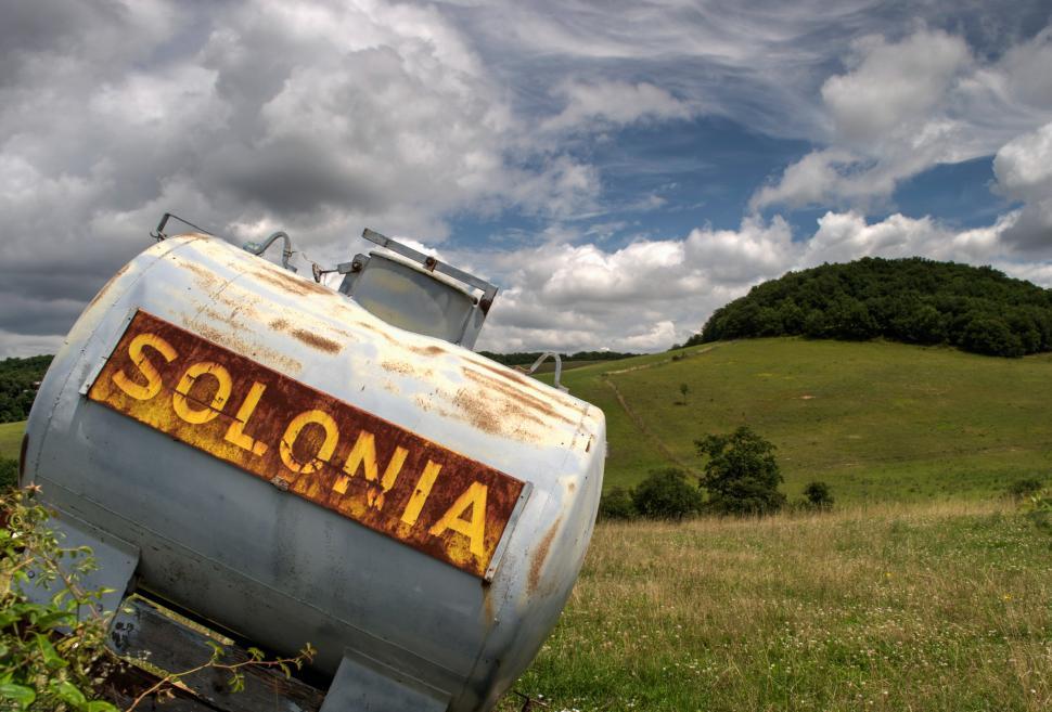 Free Image of Rusty Tank in Field With Sky Background 