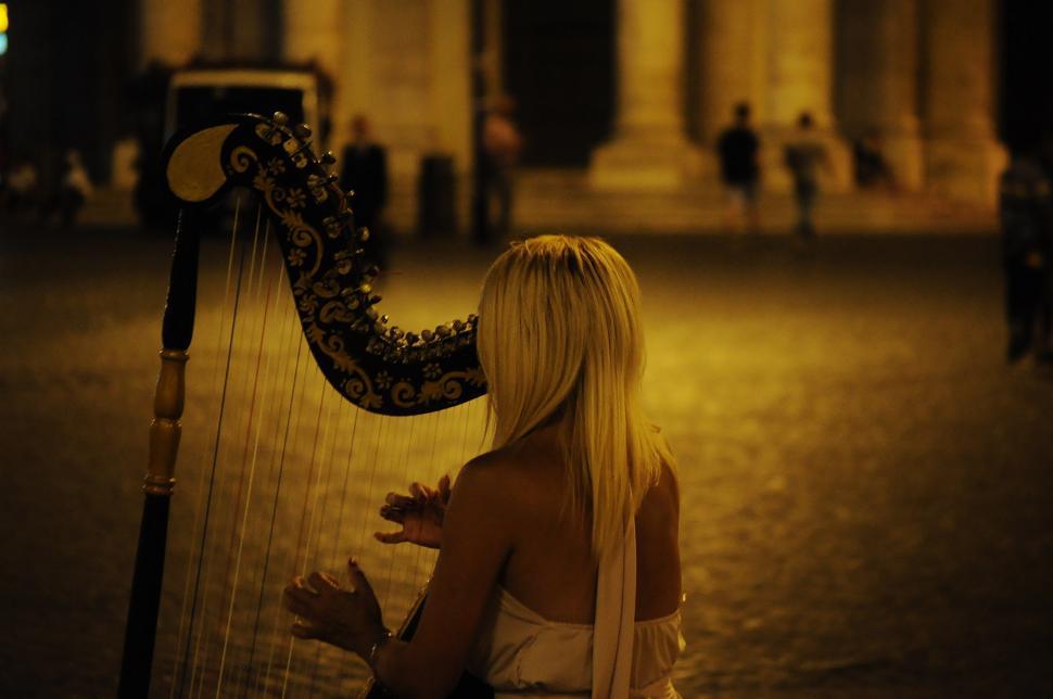 Free Image of Woman Playing Harp on the Ground 