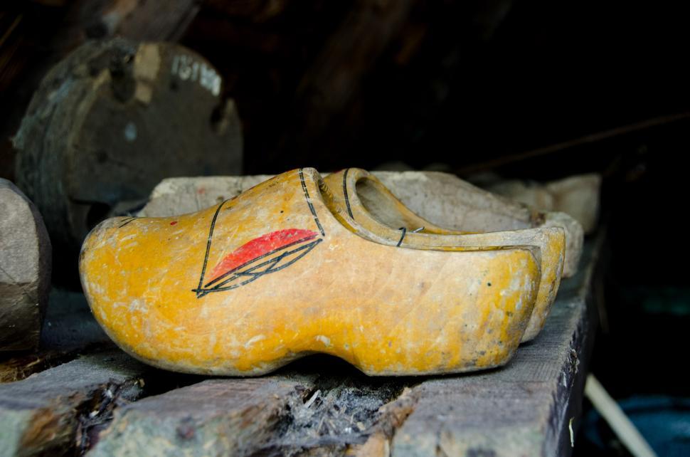 Free Image of Yellow Shoes on Pile of Rocks 