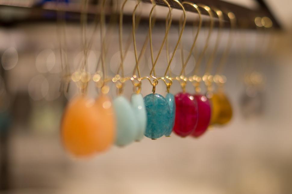Free Image of Assorted Beads Hanging From Rack 