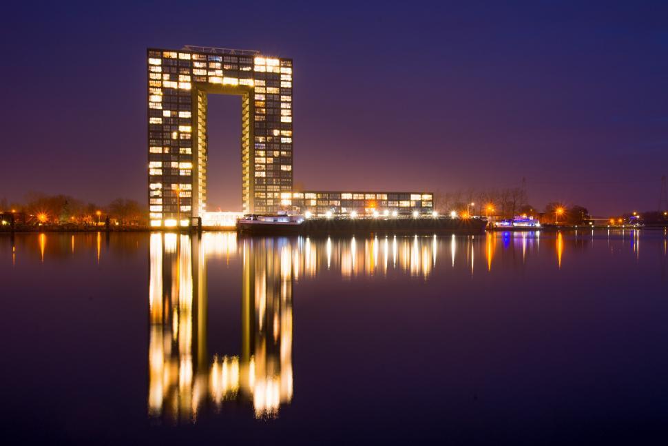 Free Image of Tall Building Rising From Middle of Water 