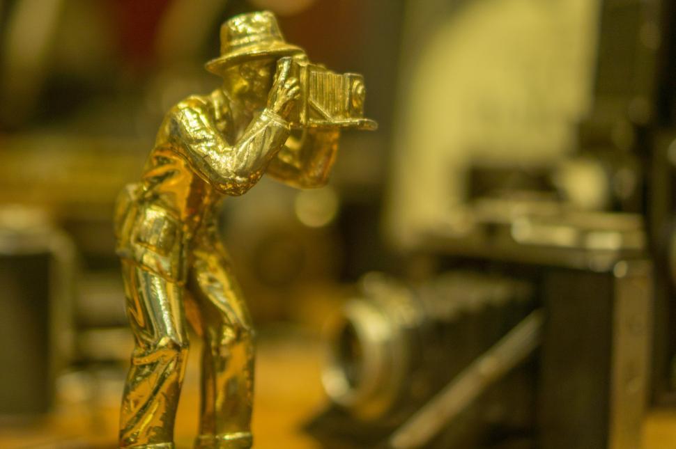 Free Image of Gold Statue of a Man Holding a Gun 