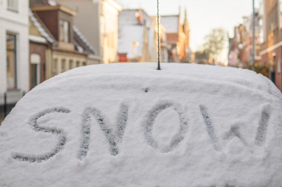 Free Image of Car Covered in Snow With Snow Written on It 