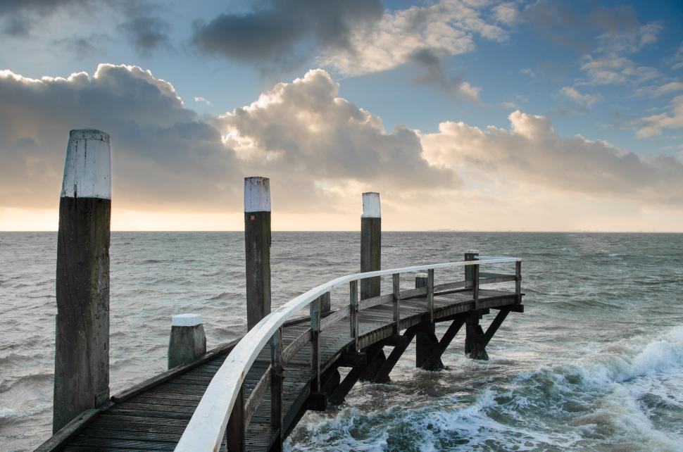 Free Image of Pier Extending Into Body of Water 
