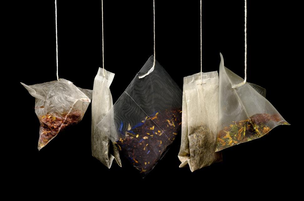 Free Image of Three Bags of Food Hanging From Strings 