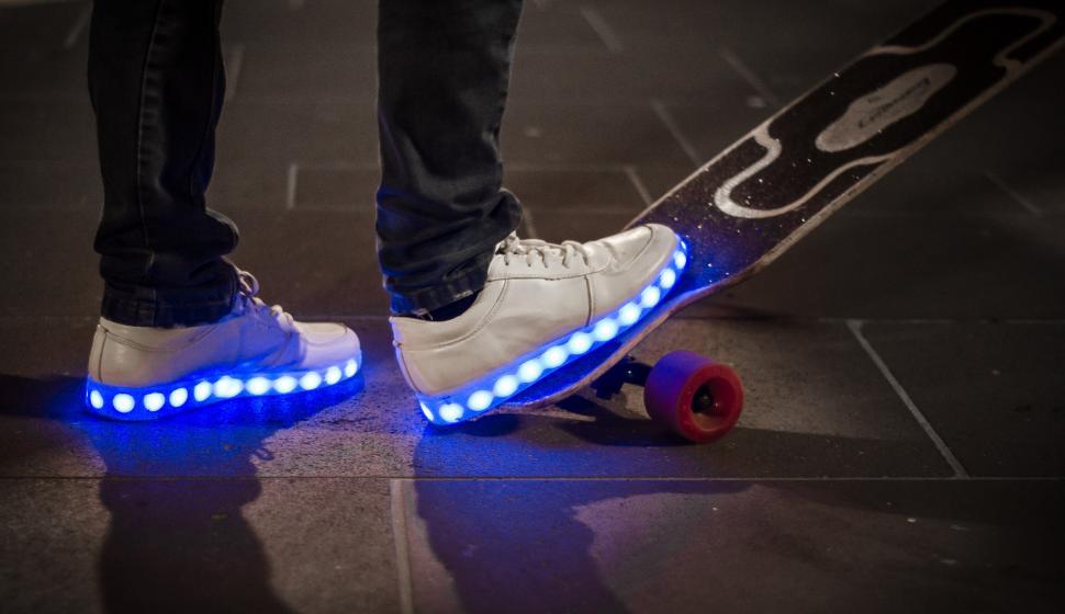 Free Image of Person Riding a Skateboard With Blue Lights 