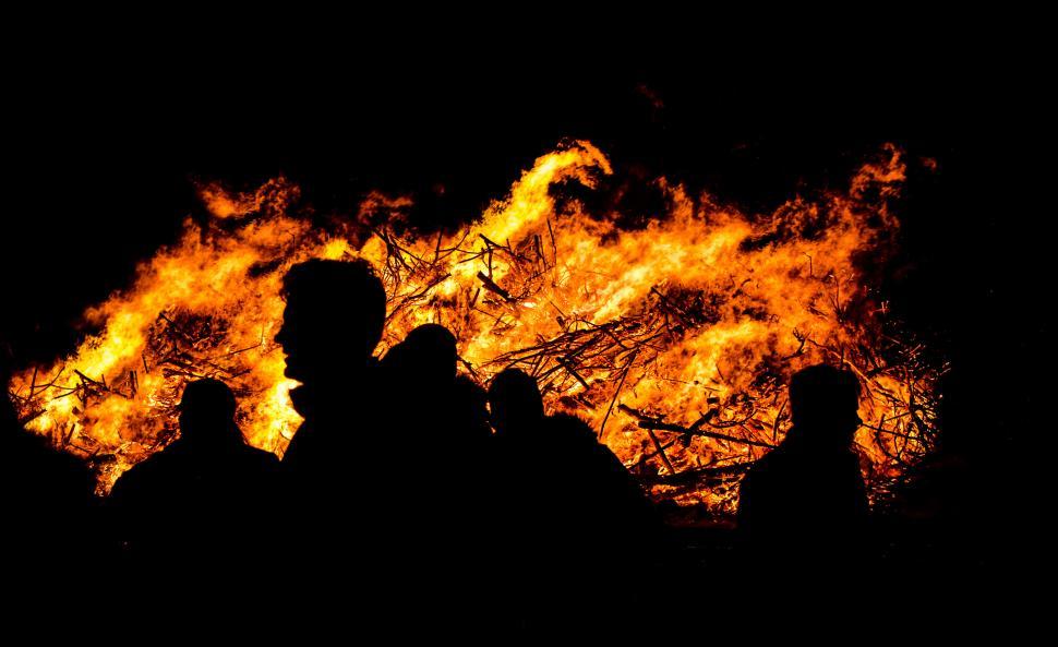Free Image of Group of People Standing in Front of a Fire 