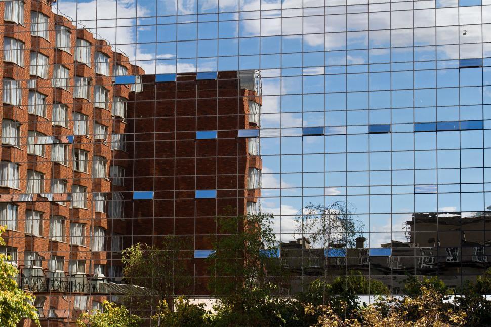 Free Image of Brick Building in Glass Building Reflection 