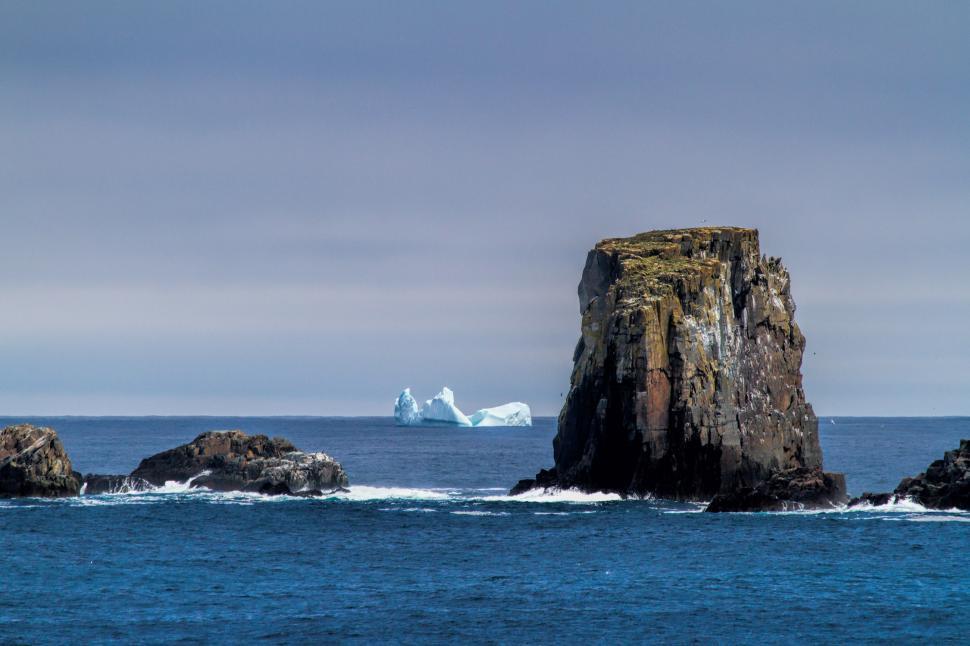 Free Image of Large sea stack with iceberg 