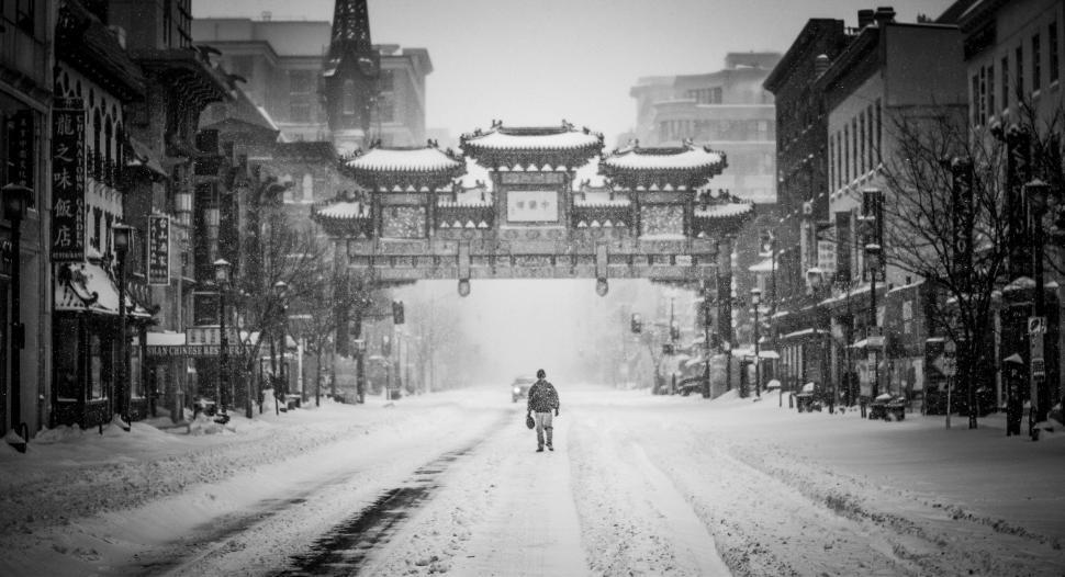 Free Image of Man Walking Down a Snow Covered Street 