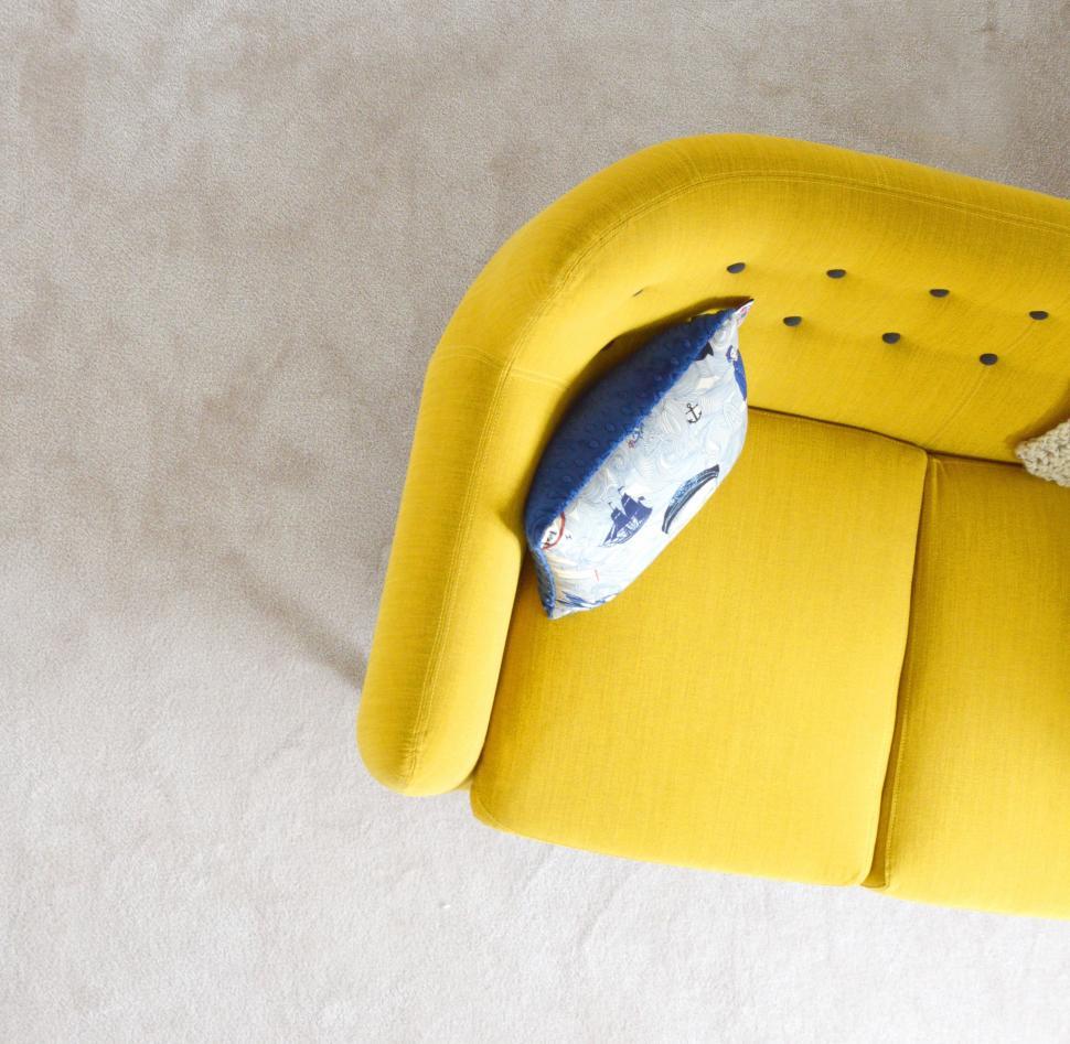 Free Image of Yellow Chair With Blue Pillow 