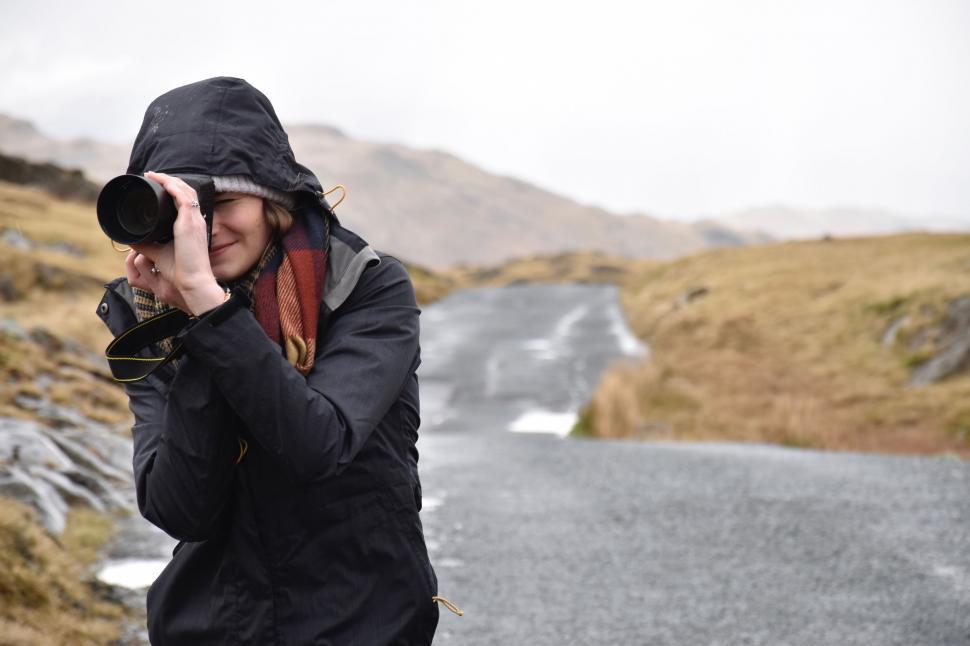 Free Image of Woman Taking Picture of Road With Camera 