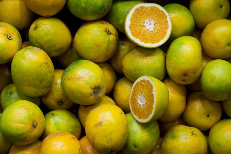 Free Image of Pile of Lemons With One Cut Half 