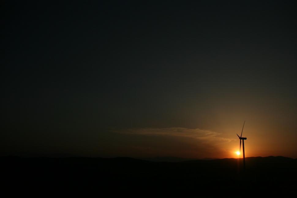 Free Image of Sun Setting Behind a Windmill in the Dark 