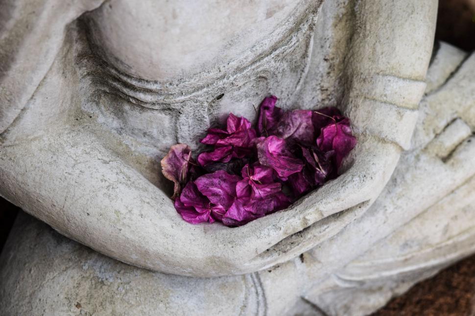 Free Image of Buddha Statue Holding a Bunch of Flowers 