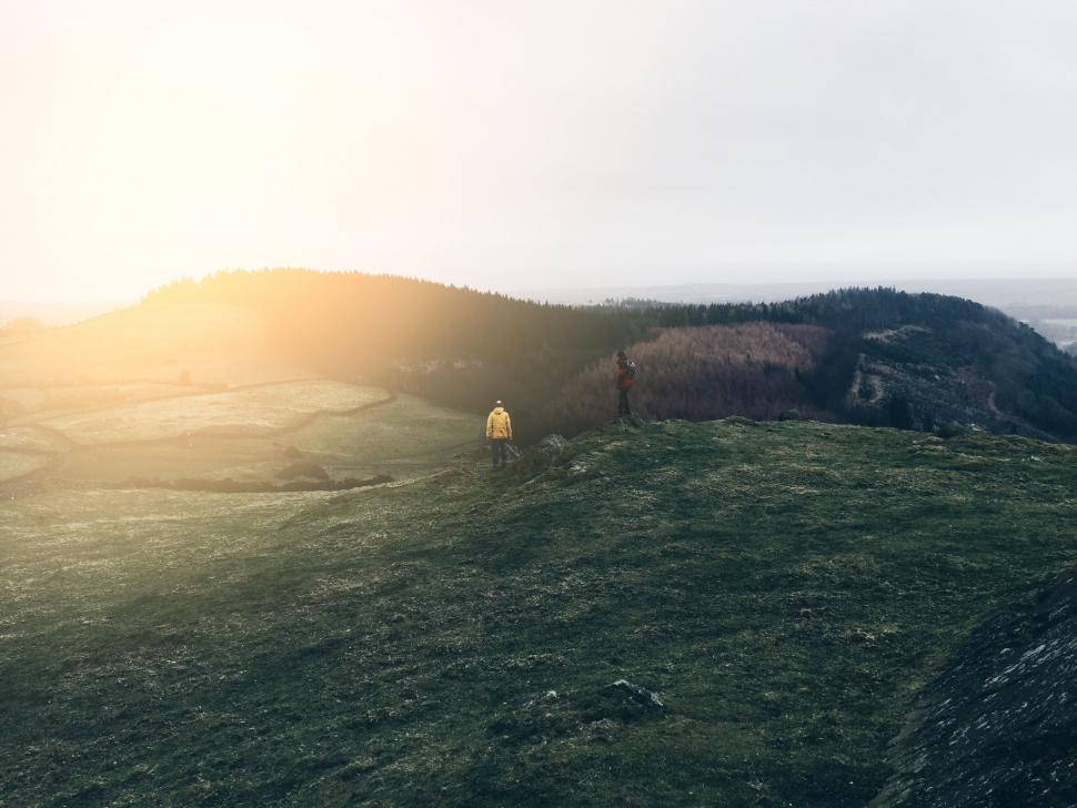 Free Image of Person Standing on Top of Lush Green Hillside 