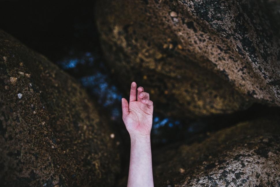 Free Image of Hand Reaching Up on Rock 