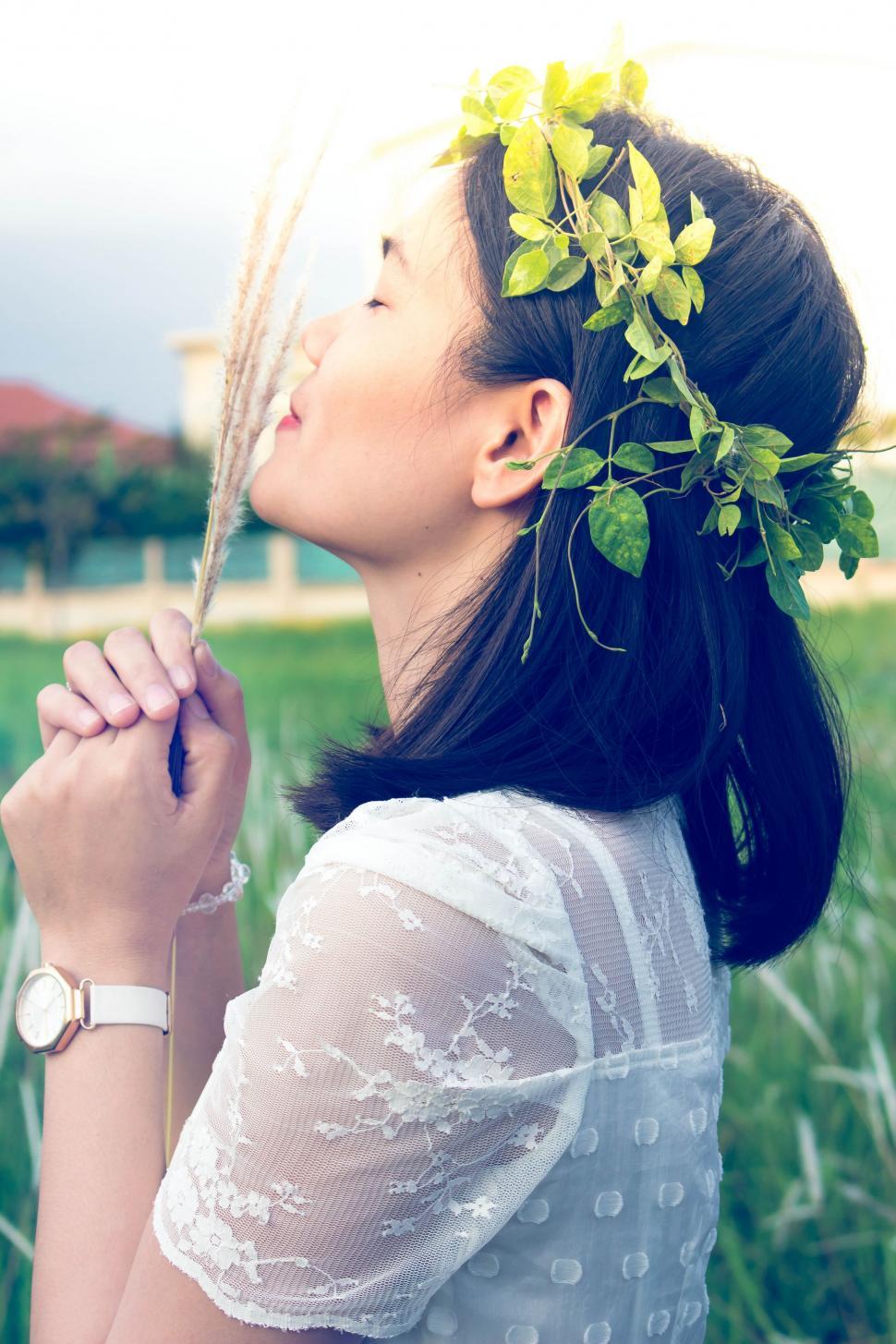 Free Image of Woman Adorning Hair With Flower 