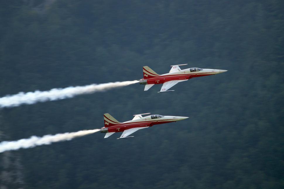 Free Image of Two Red and White Jets Flying in the Sky 