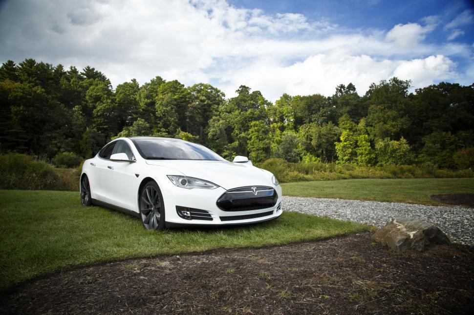 Free Image of White Car Parked on Lush Green Field 