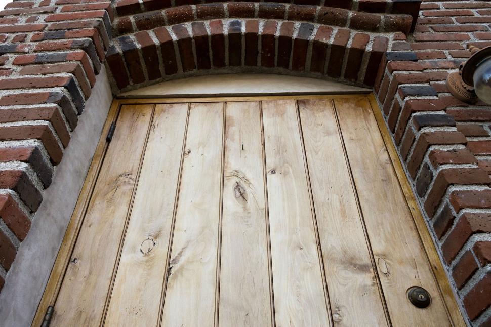 Free Image of Close Up of a Wooden Door on a Brick Building 