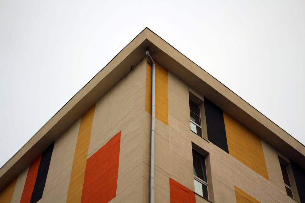 Free Image of Tall Building With Orange and White Stripes 
