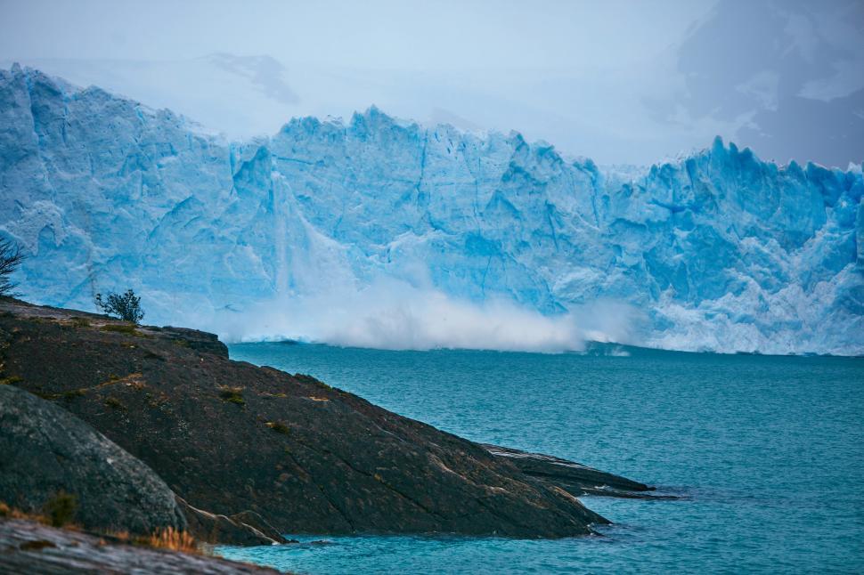 Free Image of Towering Iceberg Dominating Body of Water 