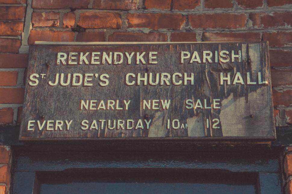 Free Image of Sign on Side of Brick Building 