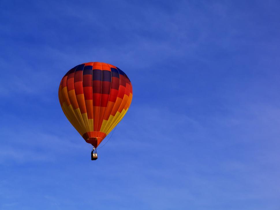 Free Image of Hot Air Balloon Flying Through Blue Sky 