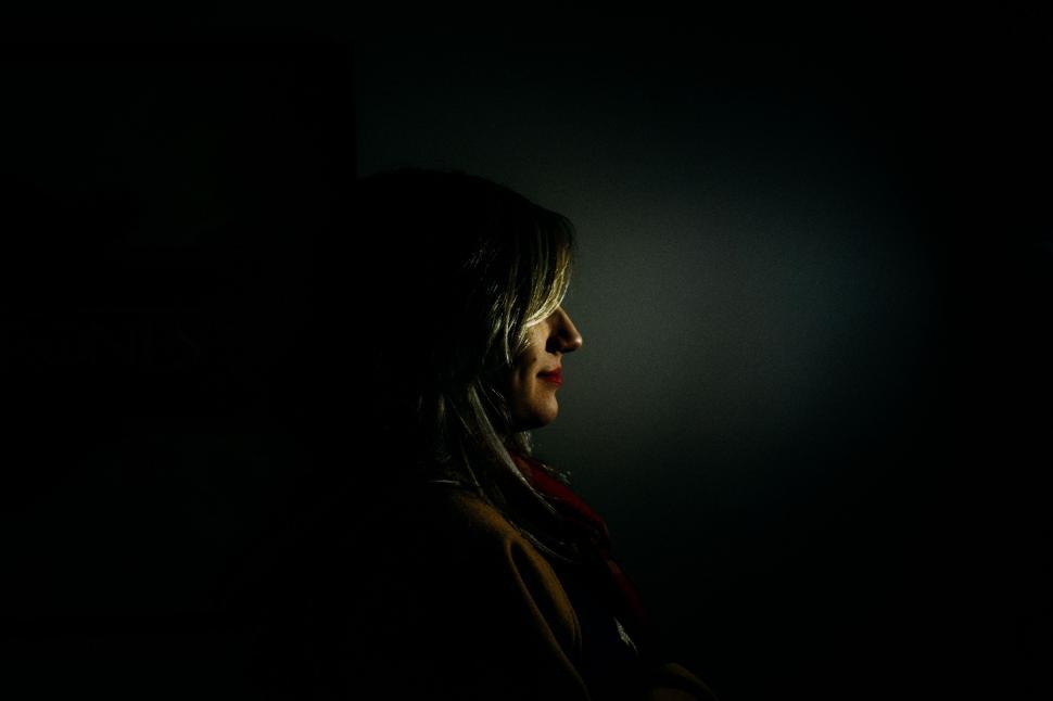 Free Image of Person Standing in Dark With Cell Phone 