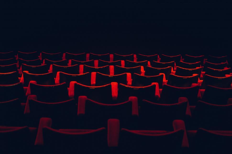 Free Image of Row of Red Chairs in Dark Room 
