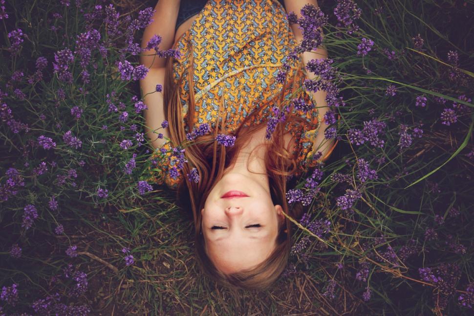 Free Image of Woman Laying in Field of Purple Flowers 
