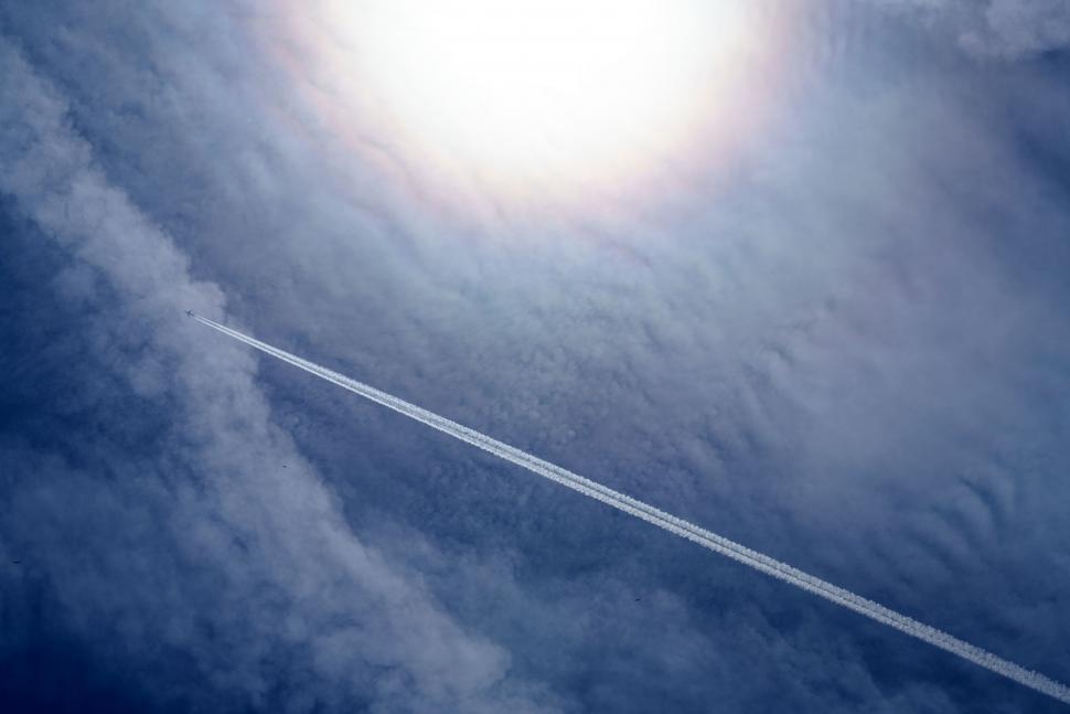 Free Image of Airplane Flying Through Clouds in the Sky 