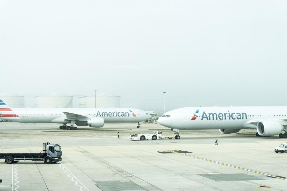 Free Image of Two Airplanes Parked on a Runway 