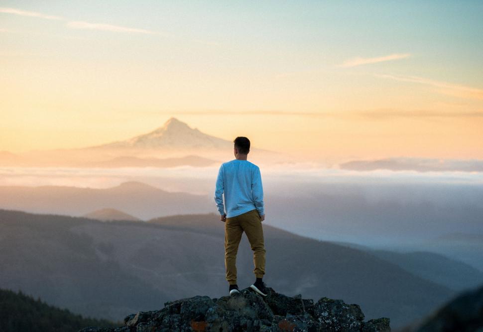 Free Image of Man Standing on Mountain Overlooking Valley 