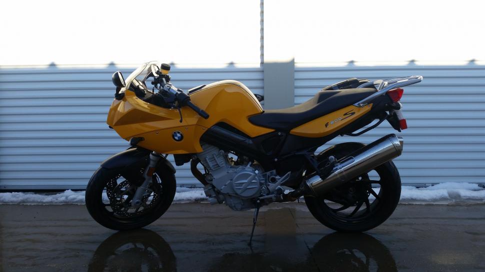 Free Image of Yellow Motorcycle Parked in Front of Building 