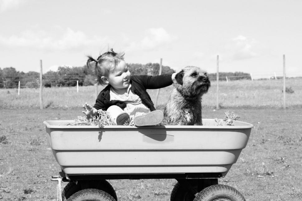 Free Image of Baby and Dog in Wagon 