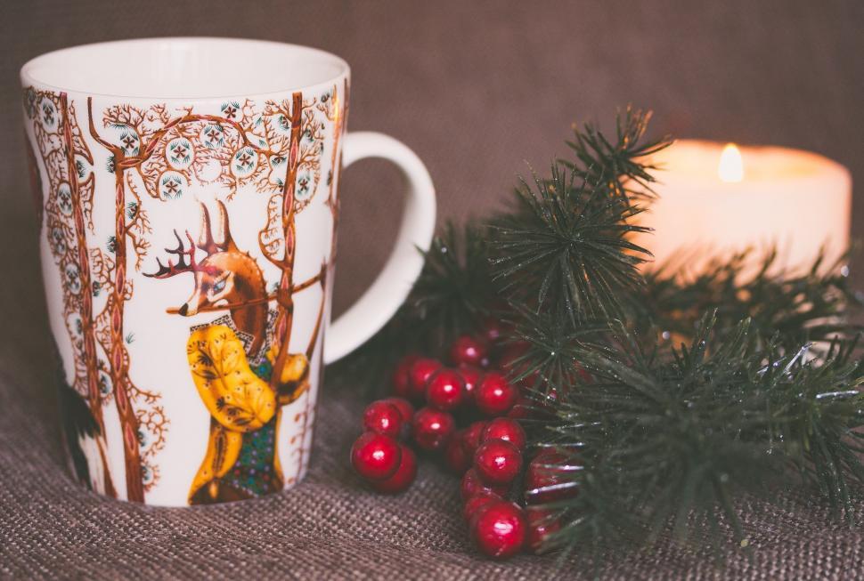 Free Image of Coffee Cup With Deer Design and Candle 