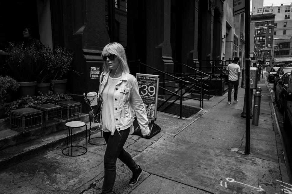 Free Image of Woman Walking Down the Street 