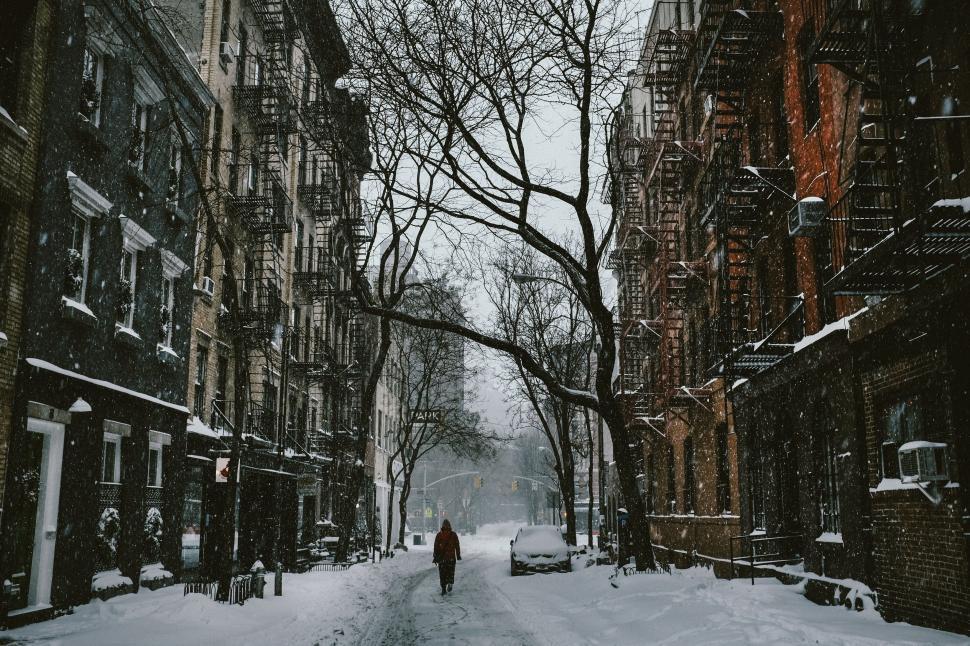 Free Image of Person Walking Down a Snow Covered Street 