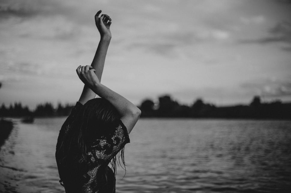 Free Image of Woman Raising Arm by Water 